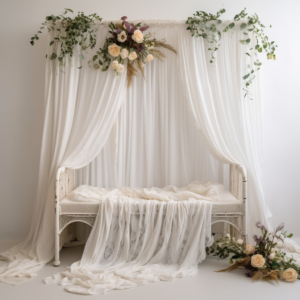 A front facing white photography backdrop for a newborn, side on view of a boho crib, white lace blanket ontop of the crib, ethereal style, draped white curtains on each side, fresh flowers, hanging flower vines trailing, rule of thirds, hyperfocal, sharp focus --style raw --v 5.2